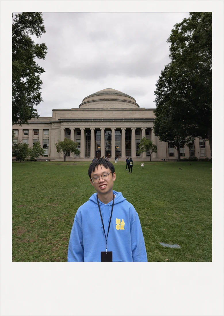 SL in a blue HackMIT hoodie on the lawn in front of MIT’s Great Dome.