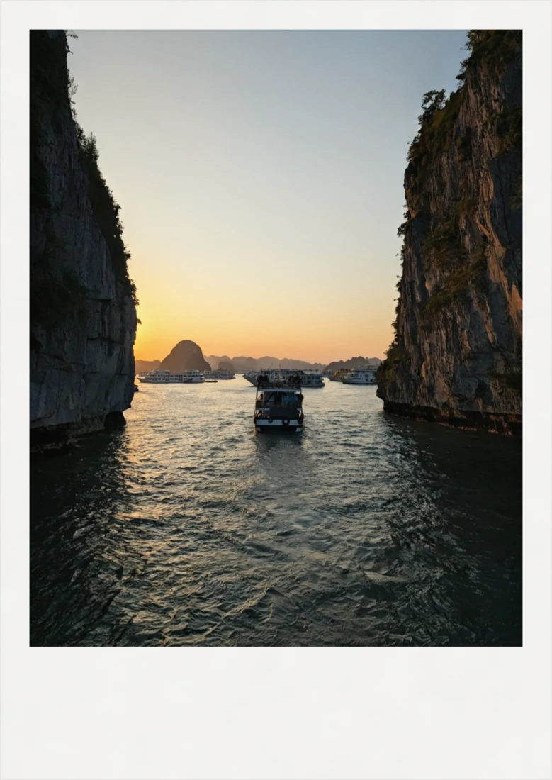 A boat between two limestone cliffs at sunset, Hạ Long Bay.